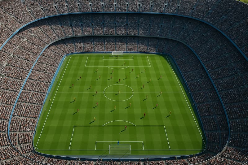 Estádio de futebol lotado visto de cima durante uma partida.